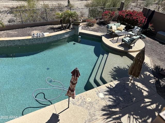 view of swimming pool with a fenced in pool and a fenced backyard