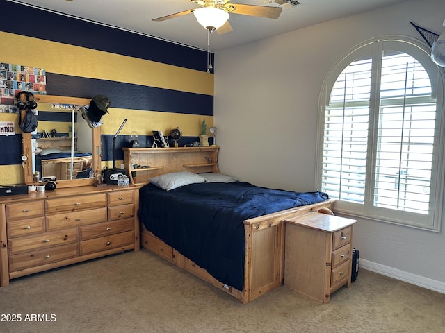bedroom featuring light carpet, visible vents, baseboards, and a ceiling fan
