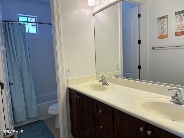 full bathroom featuring a sink, shower / bathtub combination with curtain, toilet, and double vanity