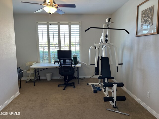 workout room with a ceiling fan, baseboards, and carpet floors