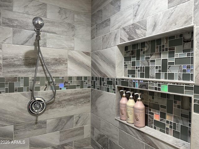 bathroom with a tile shower