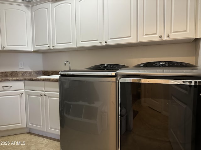 laundry area featuring washer and dryer, cabinet space, light tile patterned floors, and a sink