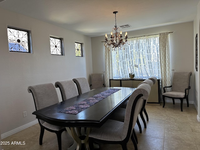 dining room featuring a chandelier, visible vents, a healthy amount of sunlight, and baseboards