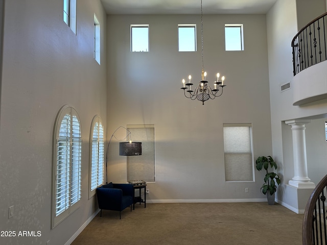 interior space featuring carpet flooring, baseboards, visible vents, and a wealth of natural light