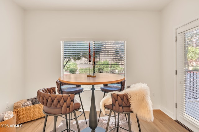 5450 E Deer Valley Dr Unit 1004, Phoenix, AZ 85054 - dining room featuring light wood-type flooring and baseboards