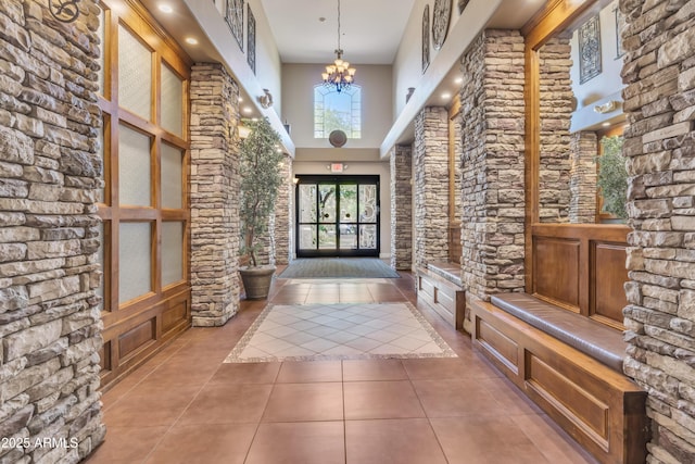 5450 E Deer Valley Dr Unit 1004, Phoenix, AZ 85054 - foyer featuring tile patterned flooring, a chandelier, and a high ceiling