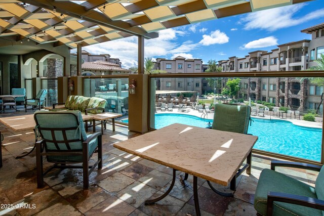 5450 E Deer Valley Dr Unit 1004, Phoenix, AZ 85054 - view of patio / terrace with a community pool and a pergola