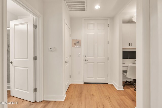 5450 E Deer Valley Dr Unit 1004, Phoenix, AZ 85054 - hall with light wood-style flooring, a desk, baseboards, and recessed lighting