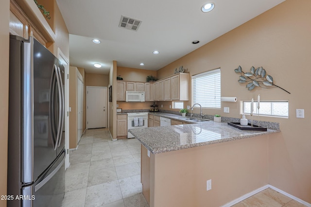 kitchen featuring a sink, white appliances, a peninsula, recessed lighting, and visible vents