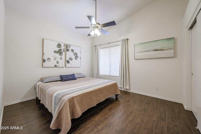bedroom featuring a ceiling fan, baseboards, dark wood finished floors, and a closet