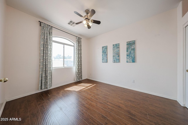 unfurnished room featuring ceiling fan, visible vents, baseboards, and dark wood-type flooring