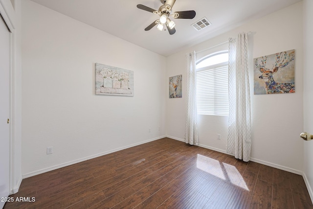 spare room with baseboards, ceiling fan, wood-type flooring, and visible vents
