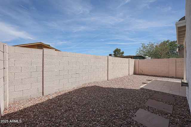 view of yard with a fenced backyard and a patio area