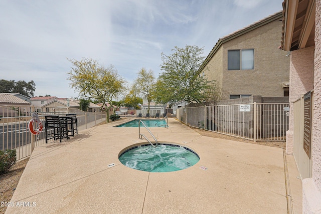 community pool with a community hot tub, a patio area, and fence