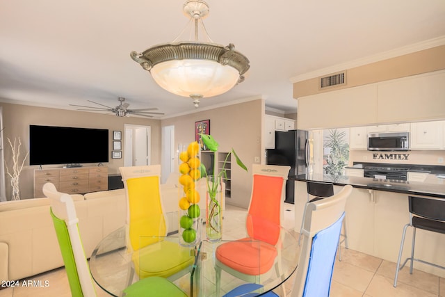 tiled dining room with crown molding and ceiling fan