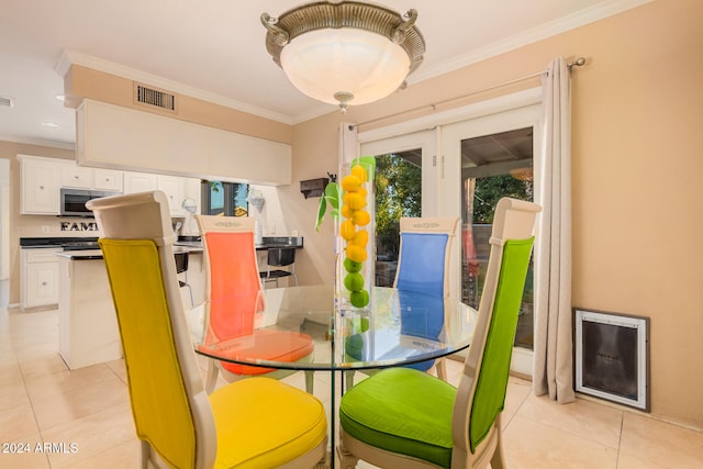 tiled dining area featuring ornamental molding