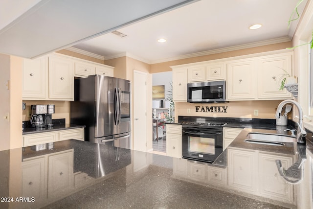 kitchen with appliances with stainless steel finishes, crown molding, white cabinetry, and sink