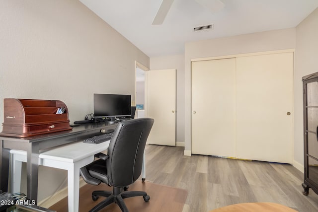 office with light hardwood / wood-style floors and ceiling fan