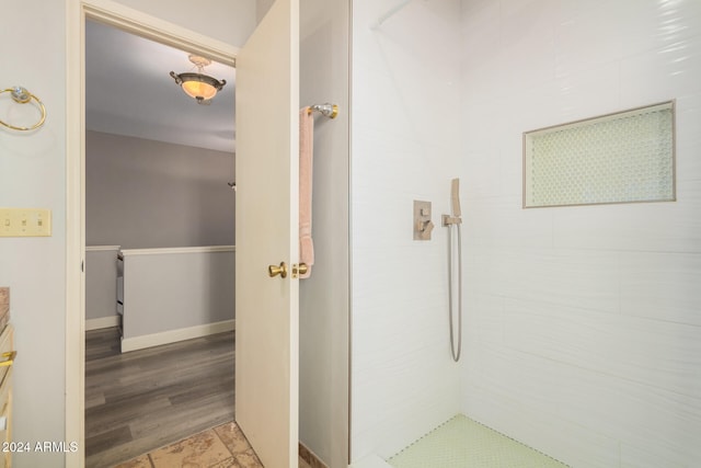 bathroom with walk in shower and wood-type flooring