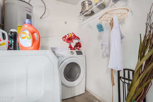 laundry room featuring water heater and separate washer and dryer