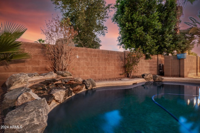 view of pool at dusk