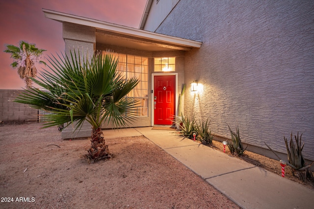 view of exterior entry at dusk