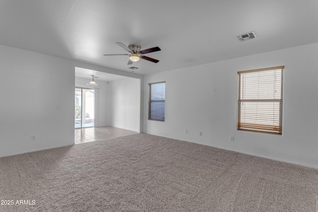 empty room featuring light colored carpet and ceiling fan