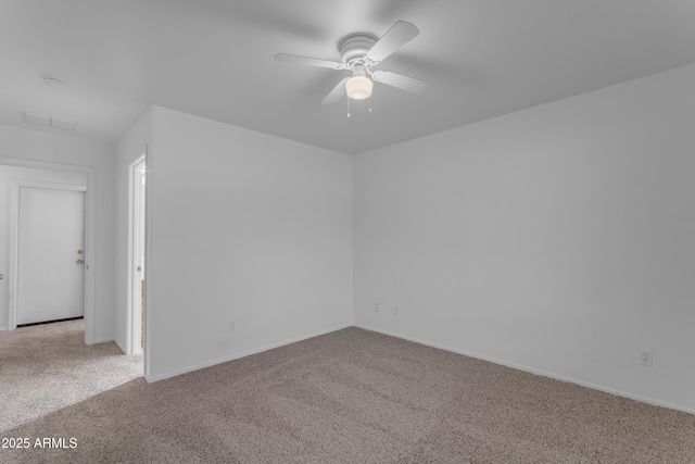 unfurnished room featuring light colored carpet and ceiling fan