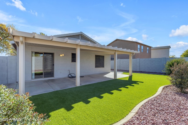 back of house featuring a patio and a lawn