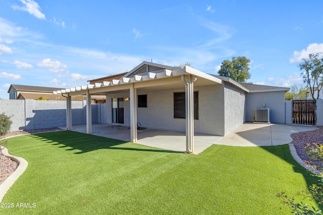 rear view of property with a patio and a lawn