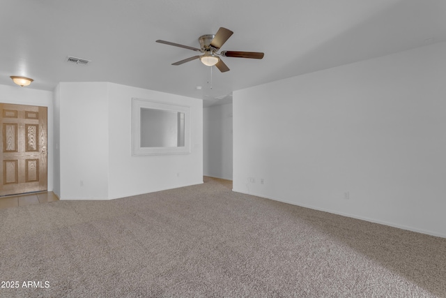 empty room featuring ceiling fan and carpet flooring