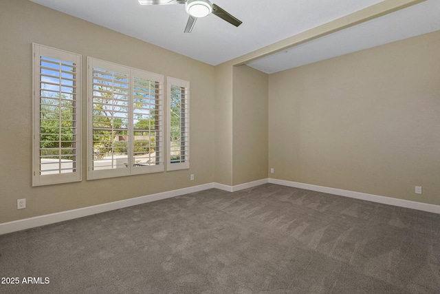 unfurnished room with ceiling fan, dark colored carpet, and baseboards