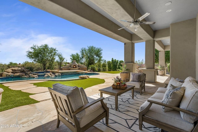 view of patio / terrace with a ceiling fan, an outdoor living space, and an outdoor pool
