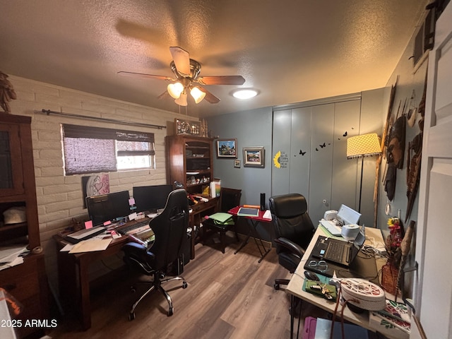 361 W Placer St, Ajo, AZ 85321 - home office featuring brick wall, a ceiling fan, wood finished floors, and a textured ceiling