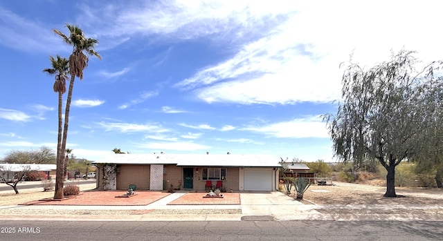 361 W Placer St, Ajo, AZ 85321 - view of front of home with an attached garage, driveway, and brick siding