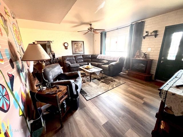361 W Placer St, Ajo, AZ 85321 - living room with brick wall, ceiling fan, and wood finished floors