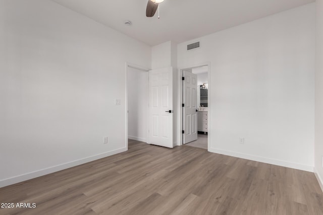 unfurnished bedroom featuring light wood-style flooring, visible vents, baseboards, and ceiling fan