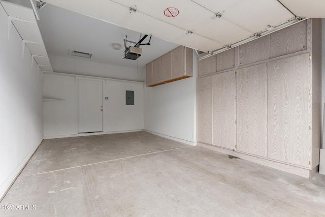 garage featuring electric panel and a garage door opener