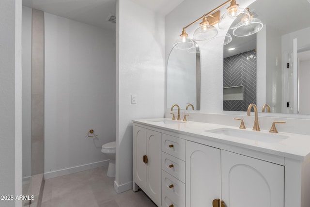 full bathroom with a sink, visible vents, toilet, and double vanity