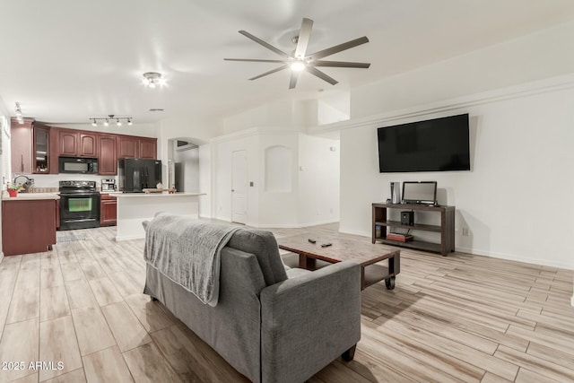 living room featuring ceiling fan and light hardwood / wood-style flooring