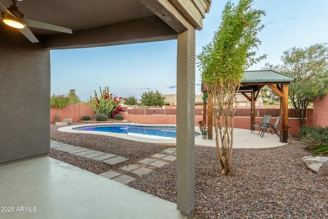 view of pool featuring a gazebo, ceiling fan, and a patio area