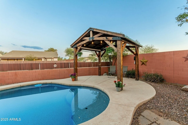 view of swimming pool featuring a gazebo and a patio