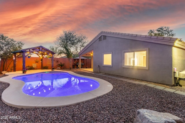 pool at dusk featuring a patio