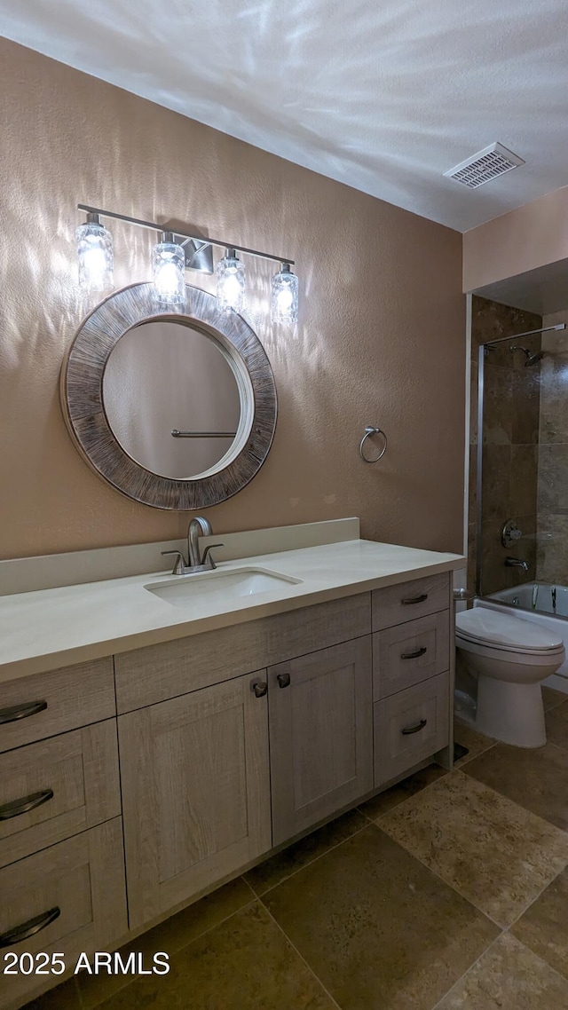 full bathroom with visible vents, a textured wall, toilet, vanity, and tile patterned flooring