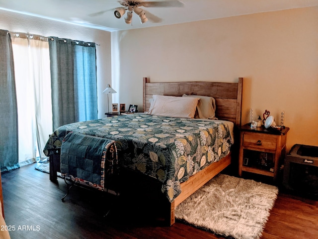 bedroom with a ceiling fan and wood finished floors