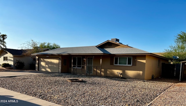 ranch-style home featuring a garage