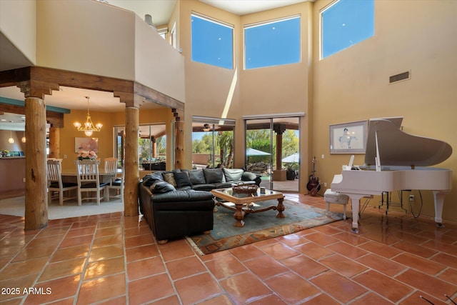 25483 N Wrangler Rd, Scottsdale, AZ 85255 - living room with ornate columns, a chandelier, a towering ceiling, and tile patterned flooring