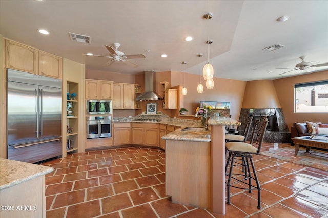 25483 N Wrangler Rd, Scottsdale, AZ 85255 - kitchen with wall chimney range hood, built in appliances, a sink, light brown cabinets, and recessed lighting