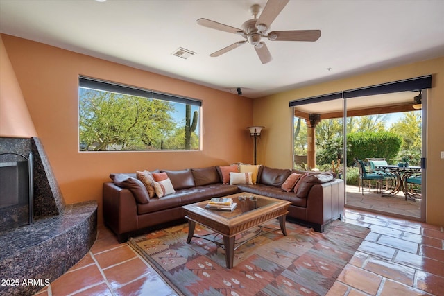 25483 N Wrangler Rd, Scottsdale, AZ 85255 - living room featuring ceiling fan, healthy amount of natural light, and a fireplace