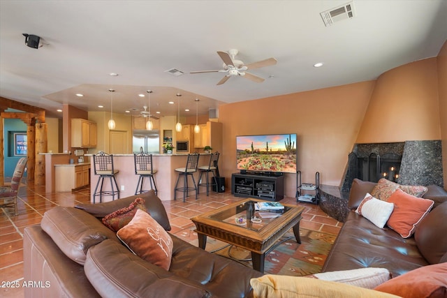 25483 N Wrangler Rd, Scottsdale, AZ 85255 - living room with ceiling fan, a fireplace, light tile patterned floors, recessed lighting, and vaulted ceiling